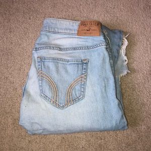 Distressed light wash jeans.